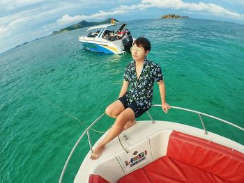 Woman sitting on boat in sea