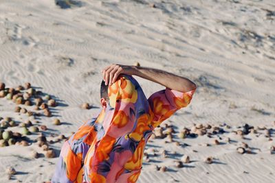 Man covering face with his shirt at beach