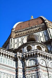 Low angle view of building against blue sky