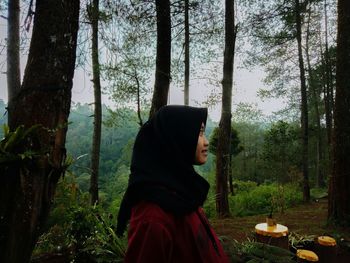 Side view of woman in forest