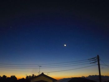 Low angle view of silhouette trees against sky at night