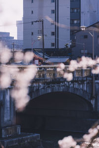 Blurred motion of bridge over buildings in city