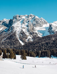 Scenic view of snowcapped mountains against clear blue sky