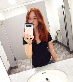 Portrait of young woman using mobile phone