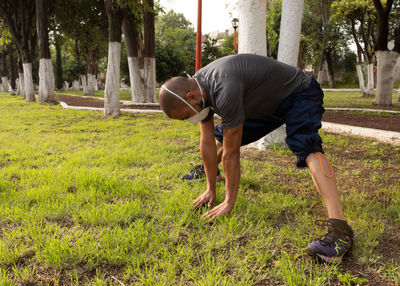 Full length of man exercising at park