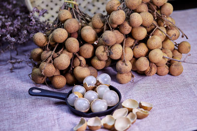 Bunch of ripe longan fruit on table