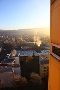 Aerial view of cityscape against sky during sunset