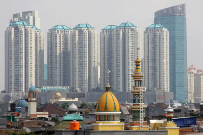 Mosque against office buildings in city