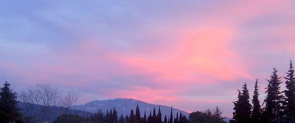 Scenic view of mountains against sky at sunset