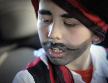 Close-up of boy with painted face in costume