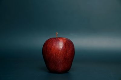 Close-up of red apple on table