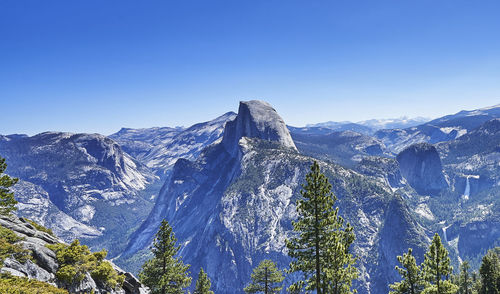 Scenic view of snowcapped mountains against clear blue sky