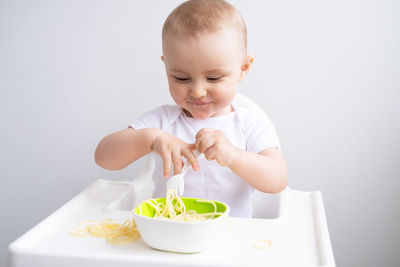 Cute smiling girl eating food at home