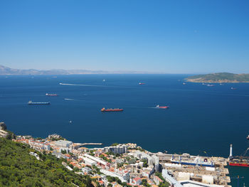 High angle view of boats in sea against blue sky