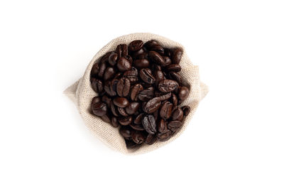 High angle view of coffee beans against white background