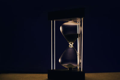 Close-up of clock falling on glass