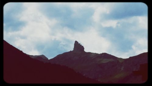 Scenic view of mountains against cloudy sky