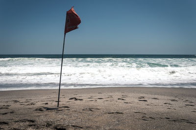 Scenic view of beach against clear sky