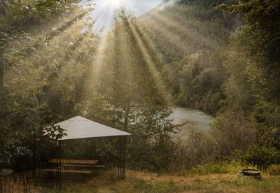 Built structure on field against trees