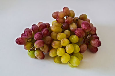 High angle view of grapes over white background