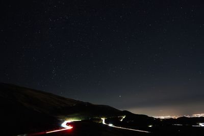 High angle view of illuminated buildings against sky at night