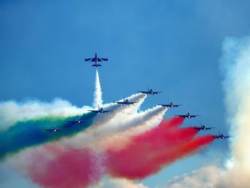 Low angle view of airshow against sky