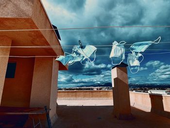 Clothes drying on building against sky