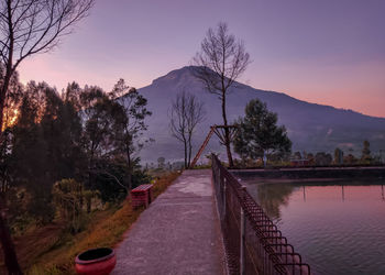 Scenic view of lake against sky at sunset