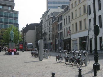 People on street amidst buildings in city