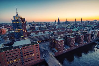 High angle view of city buildings during sunset