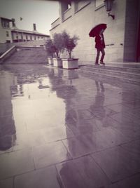 Full length of man walking in puddle