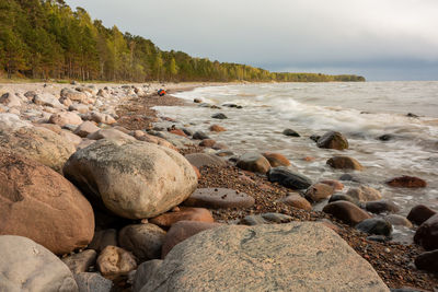 Rocks on beach against sky