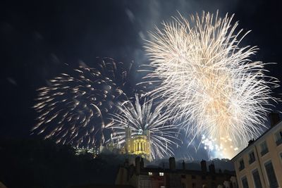 Low angle view of firework display at night