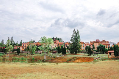 Plants and old building in city against sky