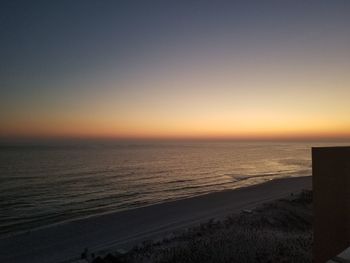 Scenic view of sea against clear sky during sunset