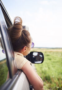 Woman peeking from car window