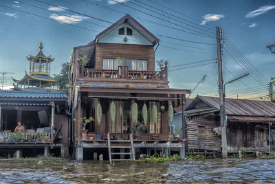 Building by river against sky