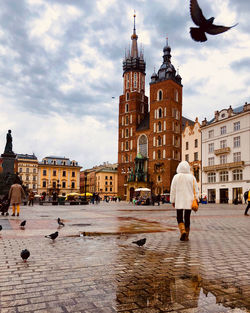 Rear view of woman walking on street in city