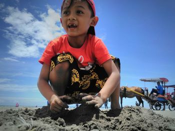 Boy wearing hat against sky