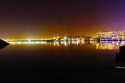 Reflection of illuminated built structure in water