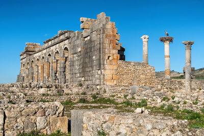 Old ruins of building against blue sky