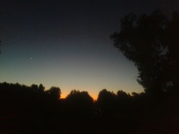 Silhouette of trees against sky at sunset