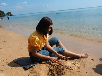 Woman sitting on beach