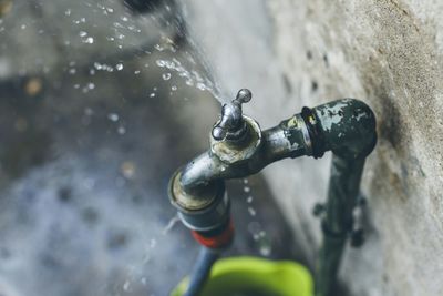 High angle view of water leaking from faucet