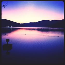 Scenic view of lake against clear sky during sunset