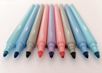 High angle view of colored pencils in row