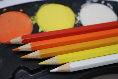 Close-up of multi colored pencils on table