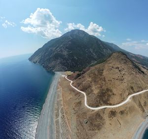 Scenic view of sea and mountains against sky