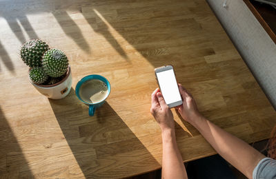 High angle view of person using laptop on table