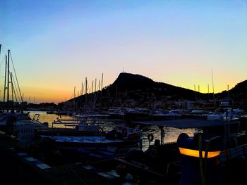 Sailboats in marina at sunset